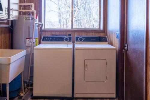 a kitchen with a stove and a refrigerator at Cardinal's Nest in Cullowhee