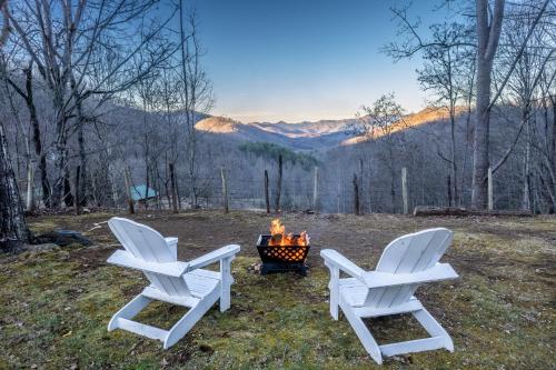 two white chairs sitting next to a fire pit at Cardinal's Nest in Cullowhee