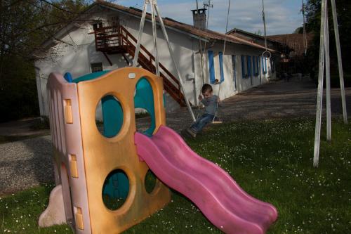 a young boy is playing on a swing at soir de lune in Lorp Sentaraille