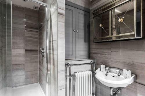 a bathroom with a sink and a shower at City Centre Georgian Townhouse in Liverpool