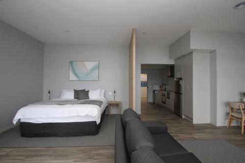 a bedroom with a bed and a living room at Waterfront Apartments in Devonport