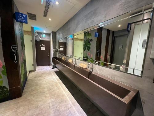 a hallway with a row of mirrors in a building at Work Inn 101 慕誠青年旅館 in Taipei