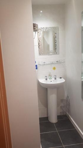 a bathroom with a white sink and a mirror at The Brema Hotel in Blackpool