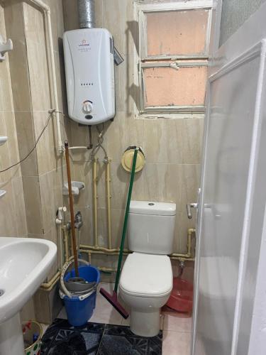 a bathroom with a toilet and a sink at A lovely apartment for rent in Cairo