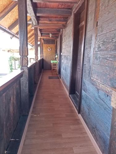 a hallway in an old building with wooden walls and a wooden floor at Family friendly house with a swimming pool Mihalic Selo, Karlovac - 20284 in Duga Resa