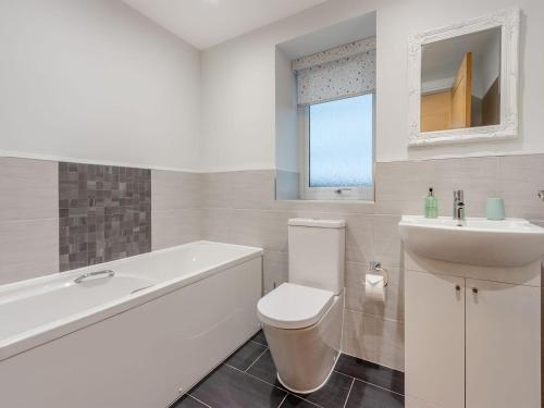 a white bathroom with a toilet and a sink at Iora Rua-uk40006 in Gartmore