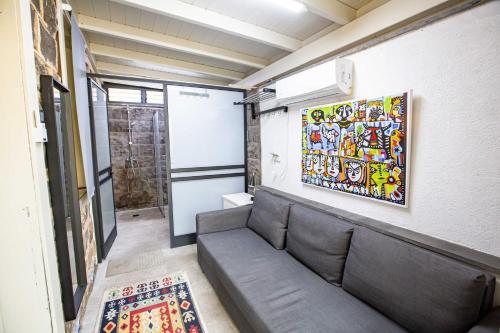 a room with a couch and a painting on the wall at Berenice Winery Hotel in Tiberias