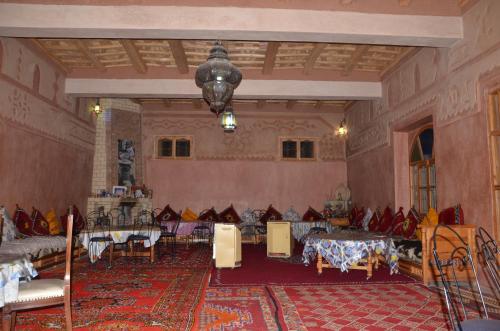 a large room with tables and chairs in it at Kasbah Ait Kassi in Boumalne