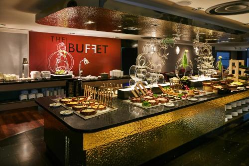 a buffet line with many different types of food at M Hotel Singapore City Centre in Singapore