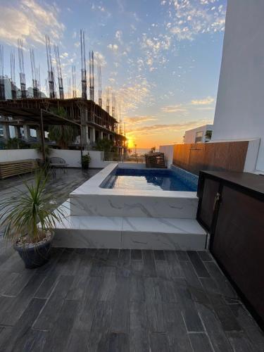 a rooftop patio with a swimming pool on a building at Pent-house a media cuadra del malecón, Hookipa Tower! in Mazatlán