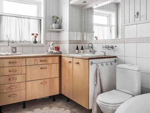 a bathroom with a toilet and a sink at 8 person holiday home in Lysekil-By Traum in Lysekil