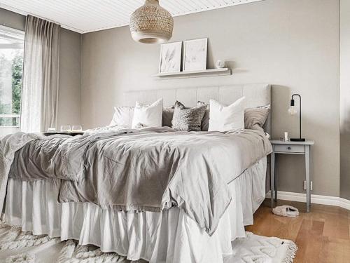 a bedroom with a large bed with white sheets and pillows at 8 person holiday home in Lysekil-By Traum in Lysekil