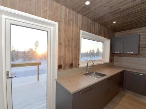 a kitchen with a sink and a counter with a window at Holiday home IDRE V in Idre