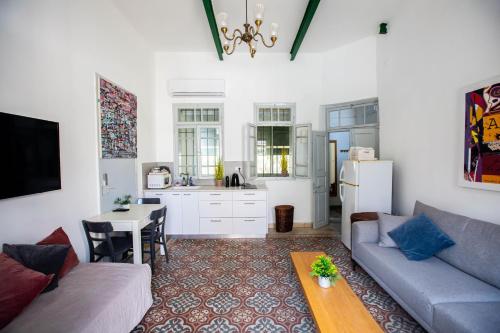 a living room with a couch and a table at Berenice Winery Hotel in Tiberias
