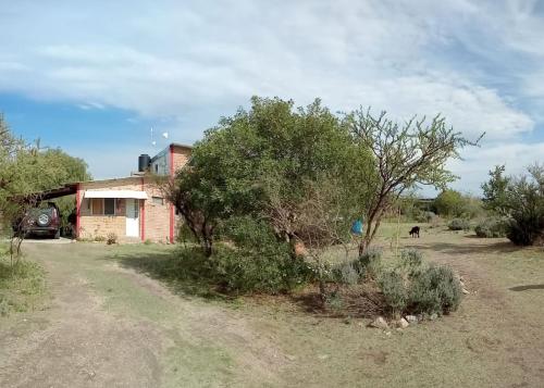 a house in the middle of a field at Madrenatura in Mina Clavero