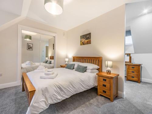 a bedroom with a large bed and a mirror at Fiadh Ruadh-uk40008 in Gartmore