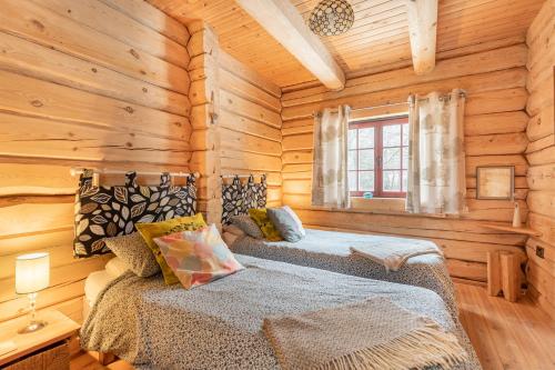 a bedroom with two beds in a log cabin at Ty Ceirios - Uk42100 in Carno