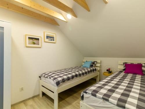 a bedroom with two beds in a attic at Comfortable, air-conditioned holiday houses, pool, sauna, Niechorze in Niechorze