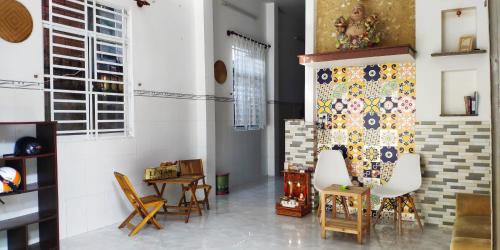 a living room with chairs and a curtain on the wall at Chill Guesthouse Can Tho in Can Tho