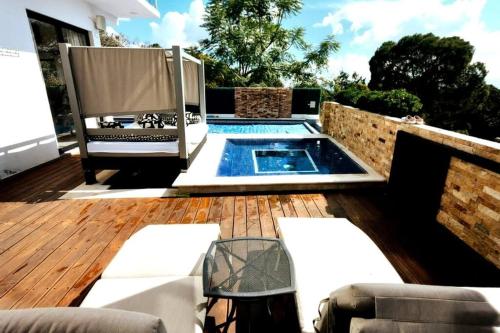 um pátio com uma piscina e um deque de madeira em Casa Aguila Gran Reserva em Ixtapan de la Sal