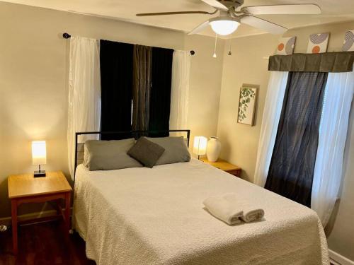a bedroom with a bed and a ceiling fan at Comfort by The University & Waterfront in Elizabeth City