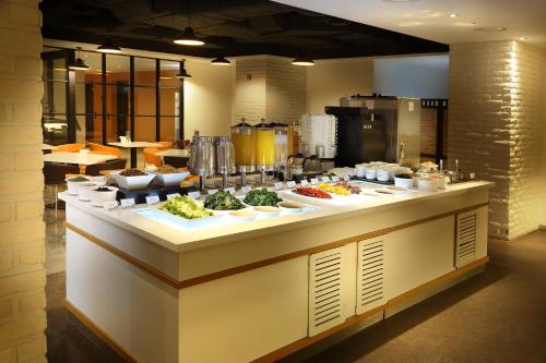 a buffet line with dishes of food on display at Travelodge Myeongdong Euljiro in Seoul