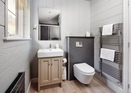 a white bathroom with a sink and a toilet at Hartsop Fold in Patterdale