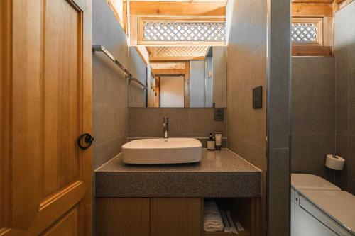 a bathroom with a sink and a mirror at Luxury hanok with private bathtub - SN09 in Seoul