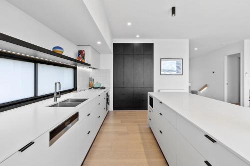 a kitchen with white counters and a large white counter top at REFLECTIONS at Lonsdale in Point Lonsdale