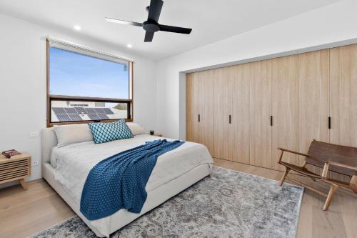a bedroom with a large bed and a window at REFLECTIONS at Lonsdale in Point Lonsdale