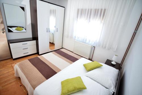 a bedroom with two beds and a large mirror at Apartment Isic in Vir