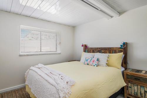 a bedroom with a bed and a window at Lazy Stays in Port Macquarie