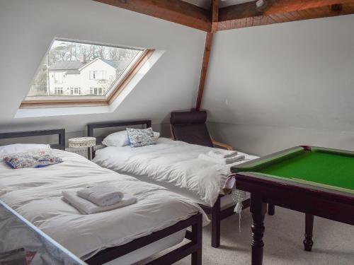 a room with two beds and a pool table at Westville in Criccieth