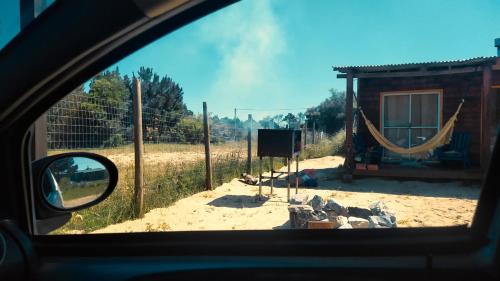 a view from a car looking out the window of a car at Glass in Punta Del Diablo