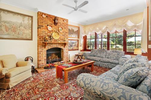 a living room with a couch and a fireplace at Montville Boutique BnB in Montville