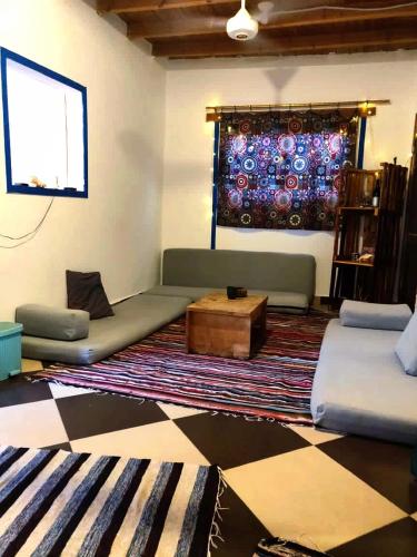 a living room with a couch and a coffee table at Moudy’s House in Dahab