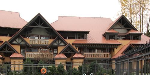 a large building with brown roofs and a fence at Sunpath Condos by Whistler Retreats in Whistler