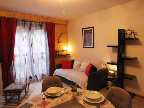 a living room with a bed and a table and chairs at Appartement Bagnères-de-Luchon, 2 pièces, 6 personnes - FR-1-313-218 in Luchon