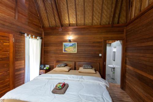 Postel nebo postele na pokoji v ubytování Bali Sesandan Garden