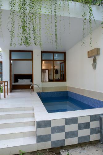 a house with a swimming pool in front of it at Balishira Resort Ltd. in Sreemangal