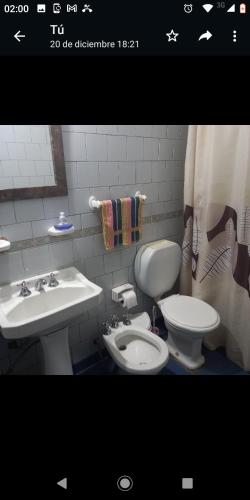 a bathroom with a toilet and a sink at DEPTO FAMILIAR dolar billete dolar blue in Gualeguaychú