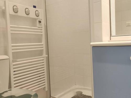 La salle de bains blanche est pourvue d'une douche et d'un réfrigérateur. dans l'établissement Appartement Calme avec Piscine, Proche Marché et Commerces - Saint-Georges d'Oléron - FR-1-246A-117, à Saint-Georges-dʼOléron