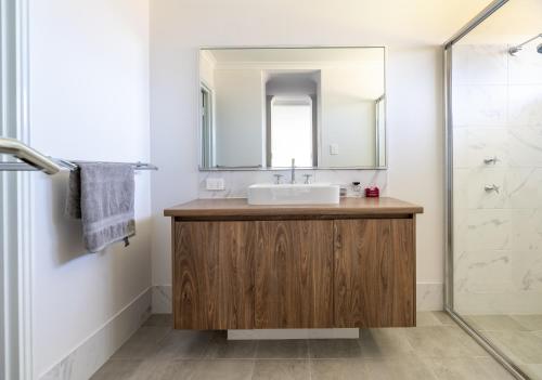 a bathroom with a sink and a mirror at Rileystone in Margaret River Town