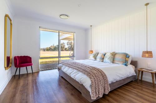 a bedroom with a large bed and a large window at Rileystone in Margaret River Town