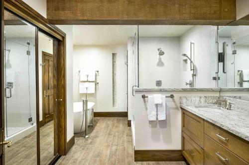 a bathroom with a shower and a sink and a tub at Luxury Three Bedroom Suite with Mountain Views and Three Hot Tubs apartment hotel in Park City