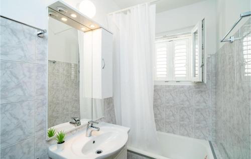 a white bathroom with a sink and a shower at Gorgeous Home In Slano With House Sea View in Slano