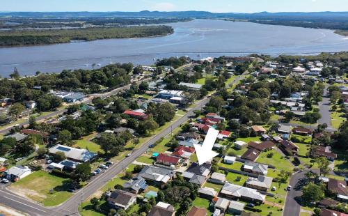 an aerial view of a town next to a river at Anchor Iluka in Iluka