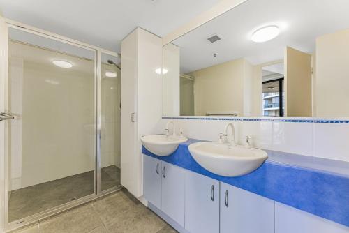 a bathroom with two sinks and a shower at Grand Pacific Unit 112 Caloundra QLD in Caloundra