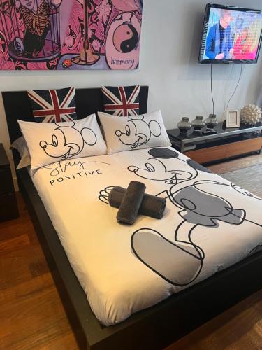 a bed with a hello kitty comforter on it at Prospect House in London