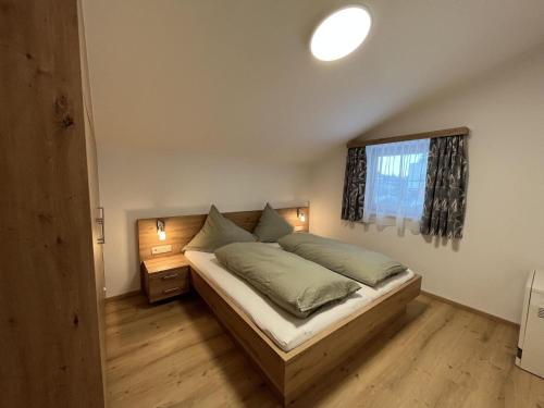 - une chambre avec un lit et une fenêtre dans l'établissement Cozy apartment in Wald im Pinzgau with balcony and barbecue area, à Wald im Pinzgau